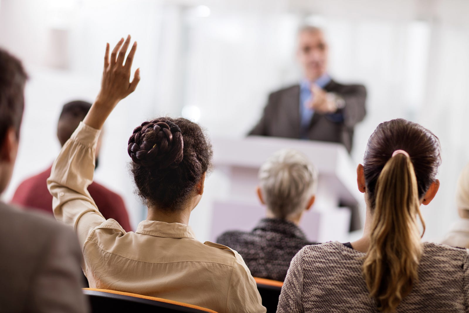 Professional raising a question in a meeting